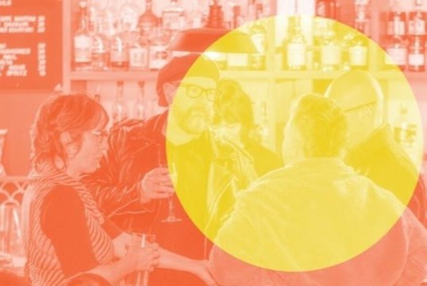 Social scene of four people gathered around a bar talking and interacting; there is large yellow circle superimposed over the orange coloured image.