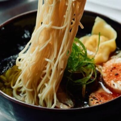 Noodles being lifted out of a bowl of ramen.