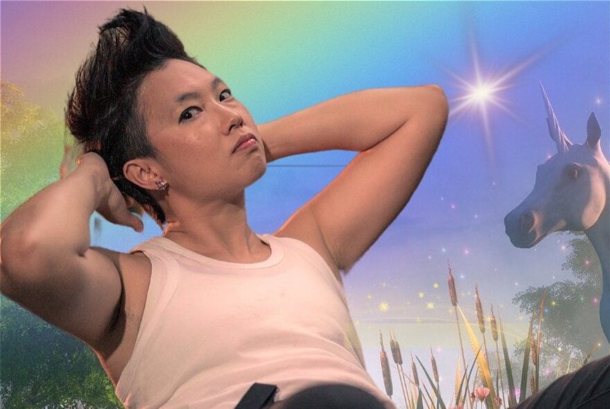 A person with short black hair, reclining back with arms behind their head, in front of a fantasy background with a bright star and unicorn.