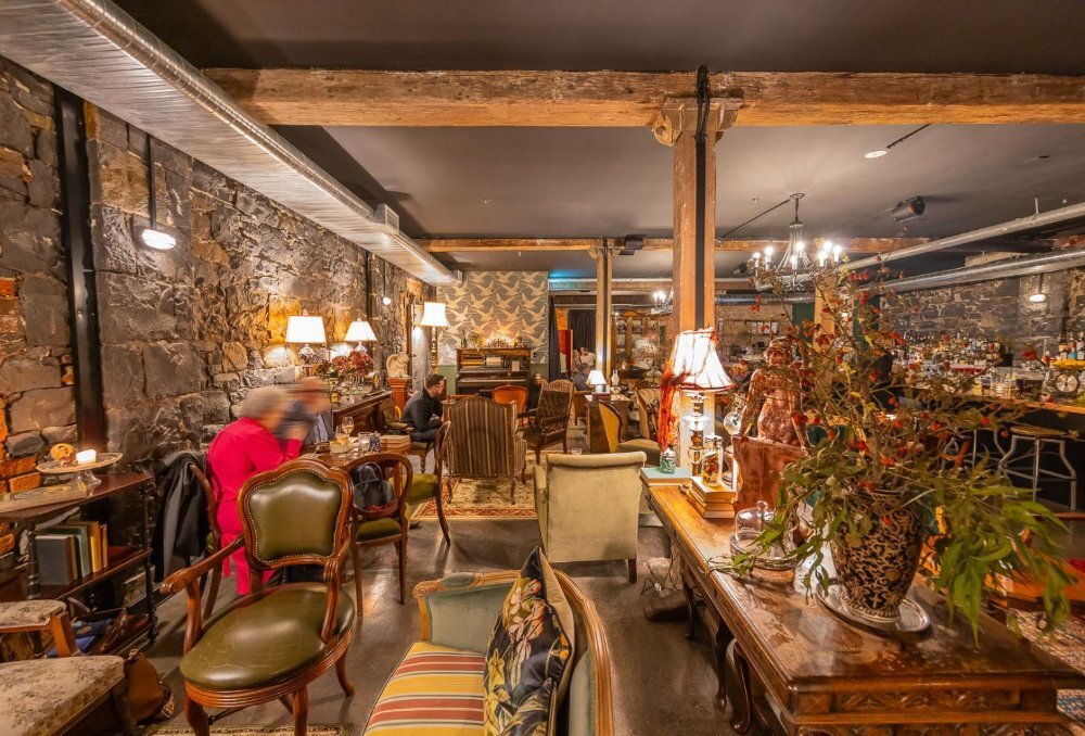 Bluestone bar filled with vintage furniture.