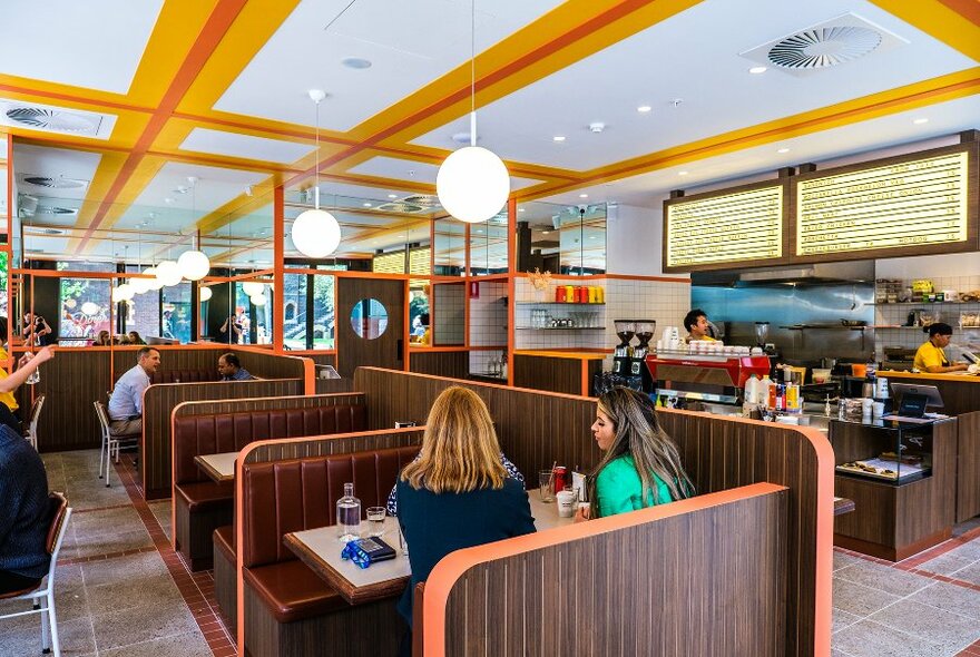 People sitting in booths in an old-school diner. 