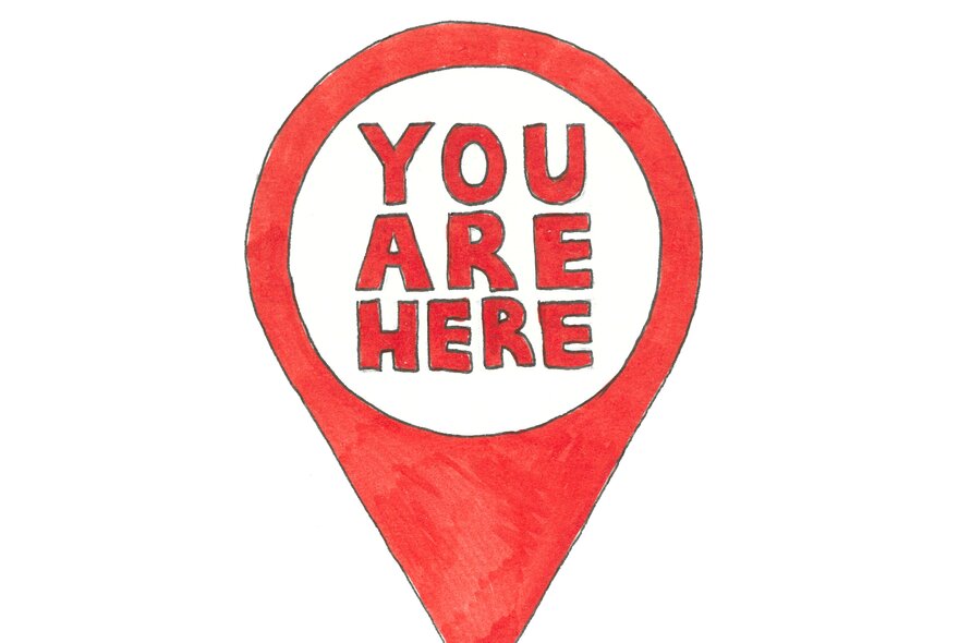 A red place marker with the words, 'You Are Here' in the white centre.