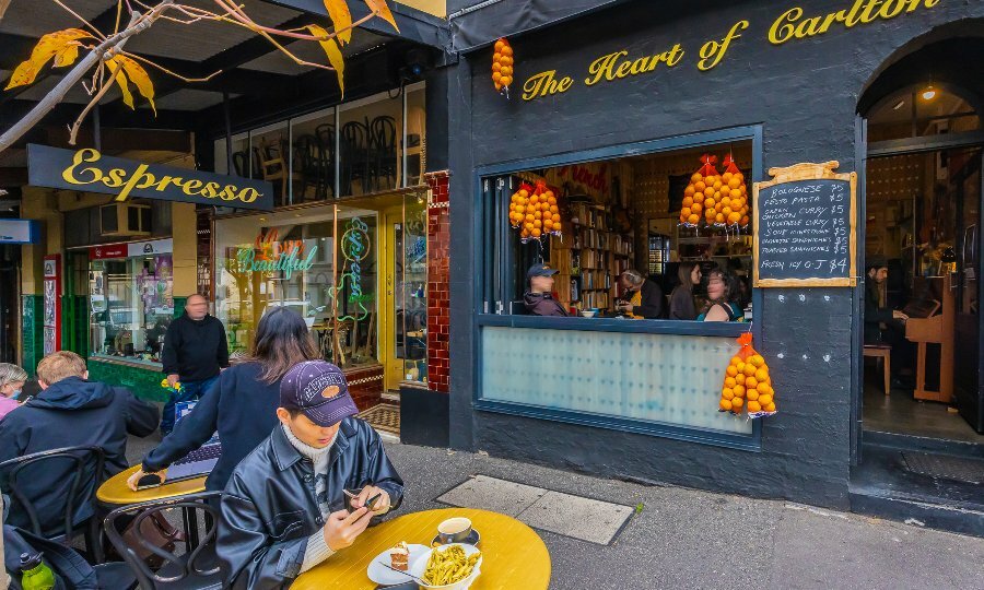 A man is sitting outside a restaurant