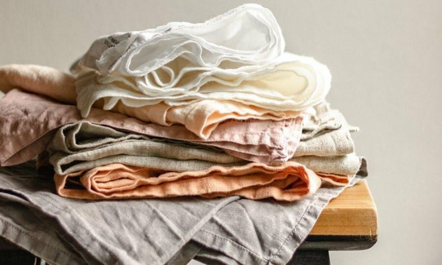 A stack of linen fabrics on a chair