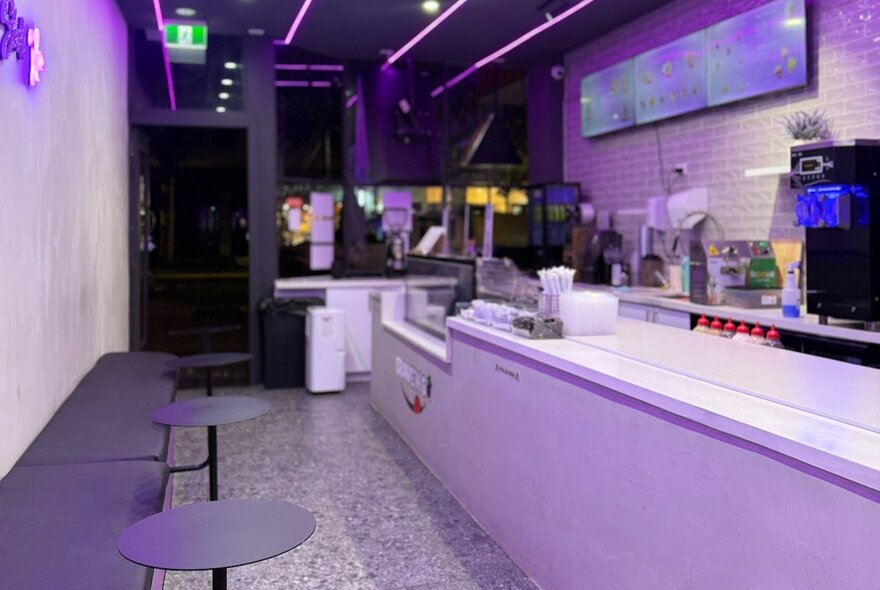 Interior of Crave N Go store in Carlton, with bench seating along one wall facing a white service counter.