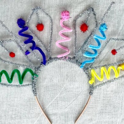 A headband with coloured and silver pipe cleaners to make a cute crown.