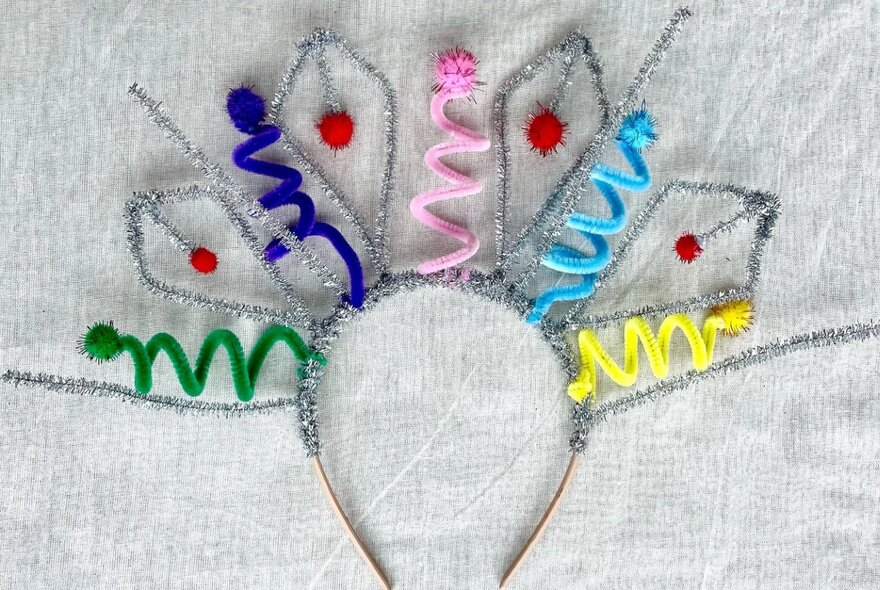 A headband with coloured and silver pipe cleaners to make a cute crown.