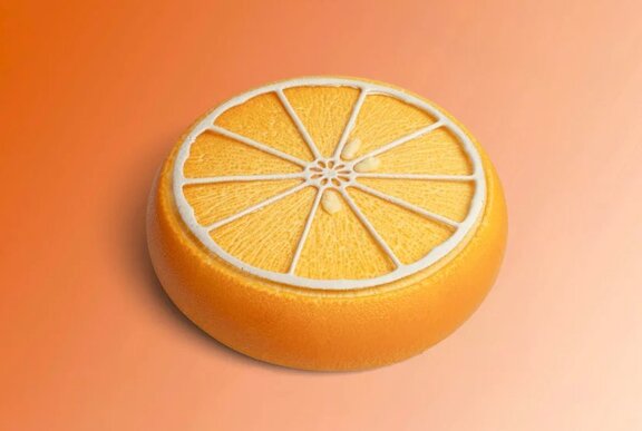 A yellow circular cake resembling a slice of the citrus fruit kumquat.