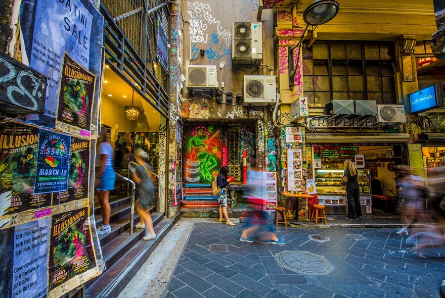 A busy laneway covered in street art and street posters