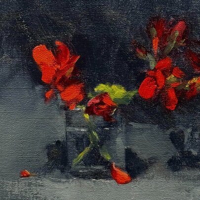 A still life painting of red flowers in a glass, some fallen petals visible. 