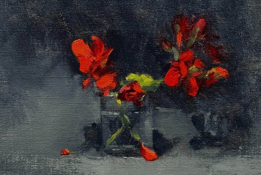 A still life painting of red flowers in a glass, some fallen petals visible. 