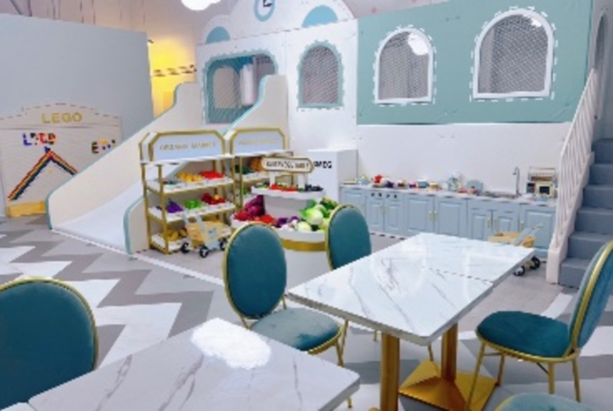 Playful interior of a cafe with tables and chairs and toys. 