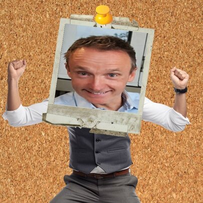 A distorted picture of a man pinned to a cork board, his face in a photo frame.