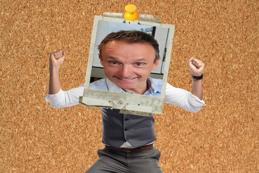 A distorted picture of a man pinned to a cork board, his face in a photo frame.