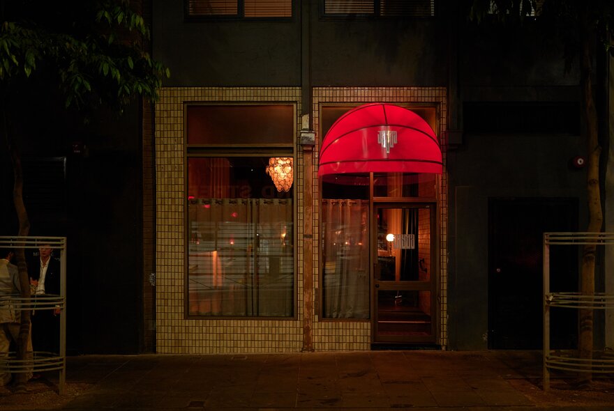 A red illuminated awning outside the bar Jayda.