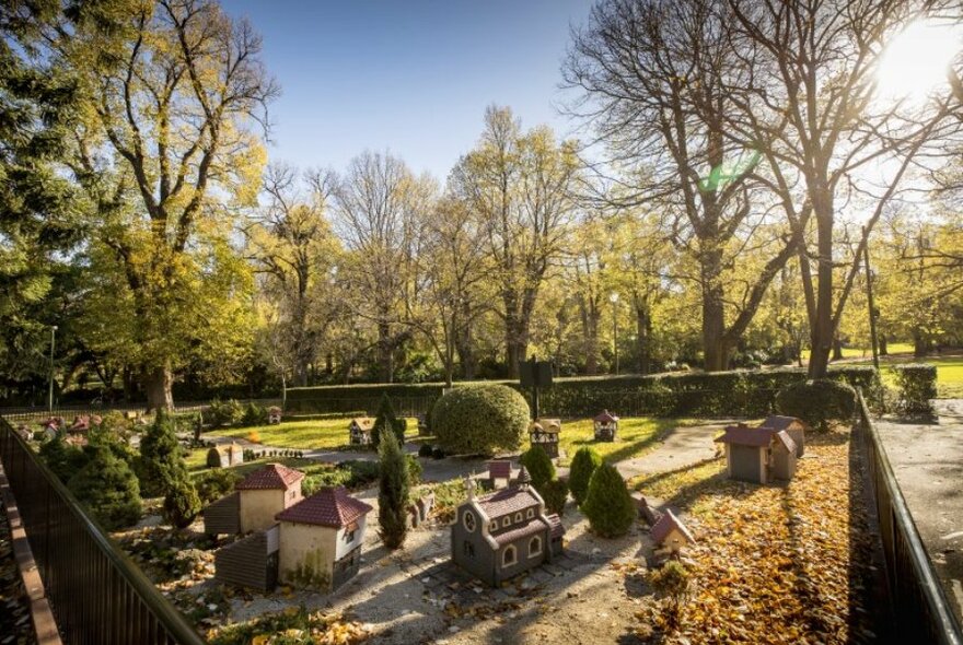 A model Tudor village in a sunny park. 