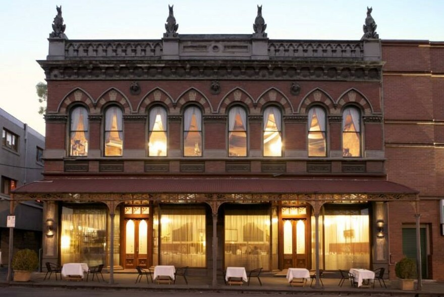 Masani exterior with gargoyles on rooftop.