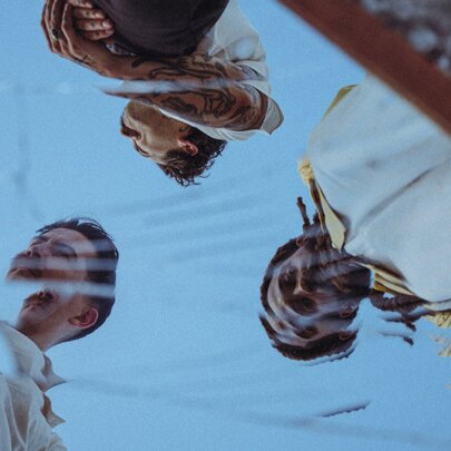 A reflection of the three members of the band Thee Sacred Souls. 