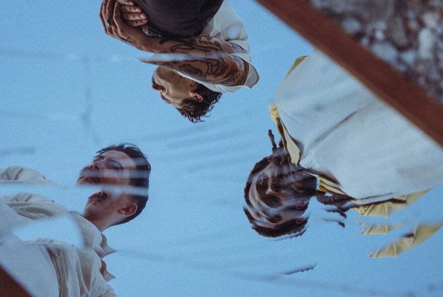 A reflection of the three members of the band Thee Sacred Souls. 