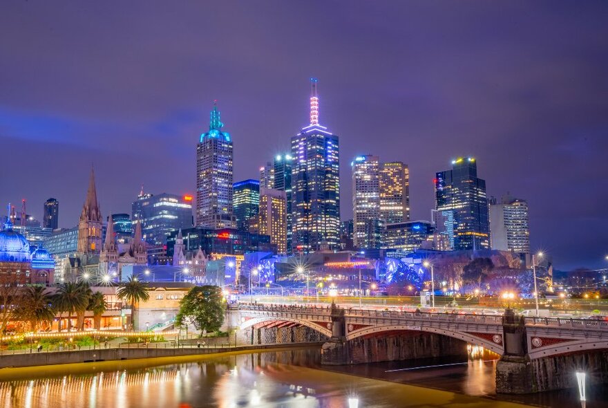 A bridge and city skyline at night