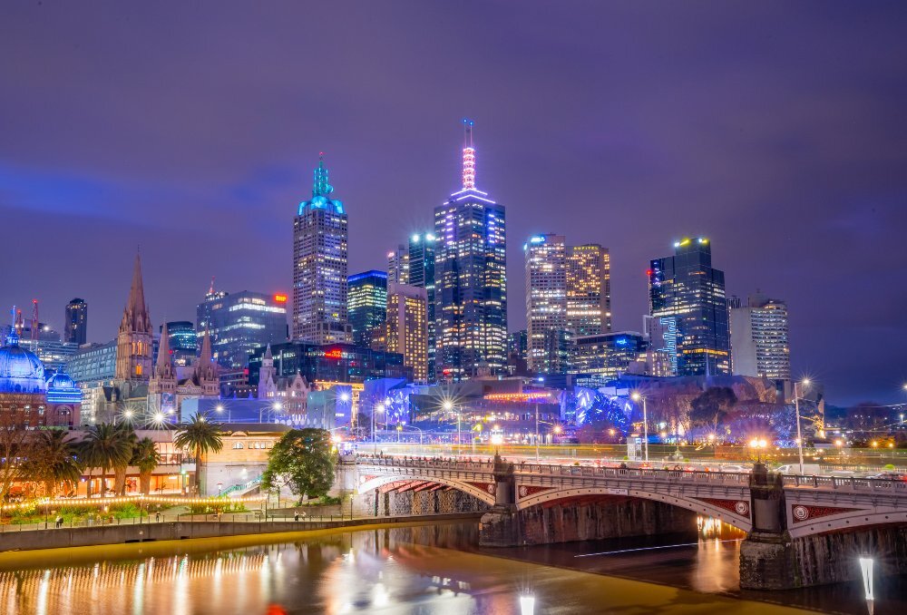 A bridge and city skyline at night
