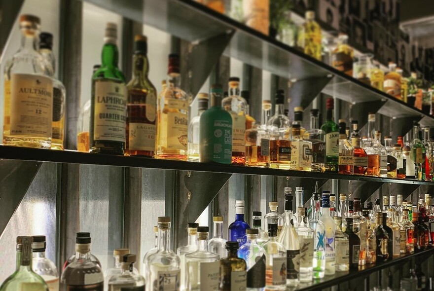 A fully stocked bar with lots of colourful bottles