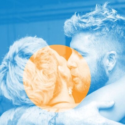 Monochrome blue-washed image of two people embracing, one about to kiss the other on the cheek, with a yellow monochrome circle in the centre. 