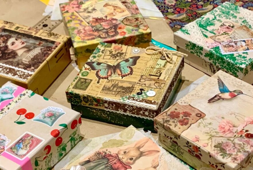 Boxes decorated with decoupage patterned papers and stickers.