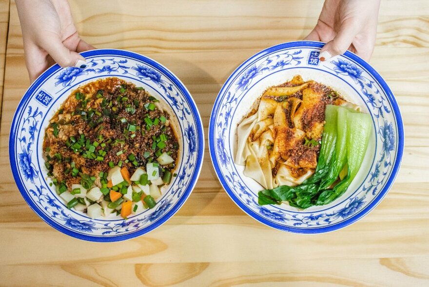 Two bowls of Chinese food, viewed from above.