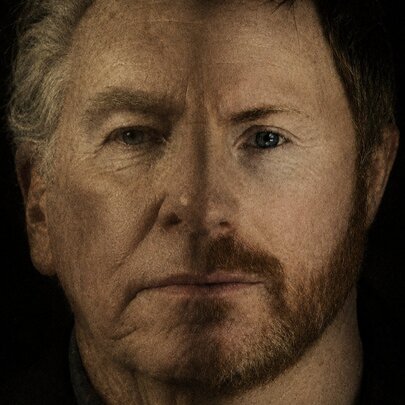 A portrait of two men merged into one face with a faint line down the centre delineating the two.