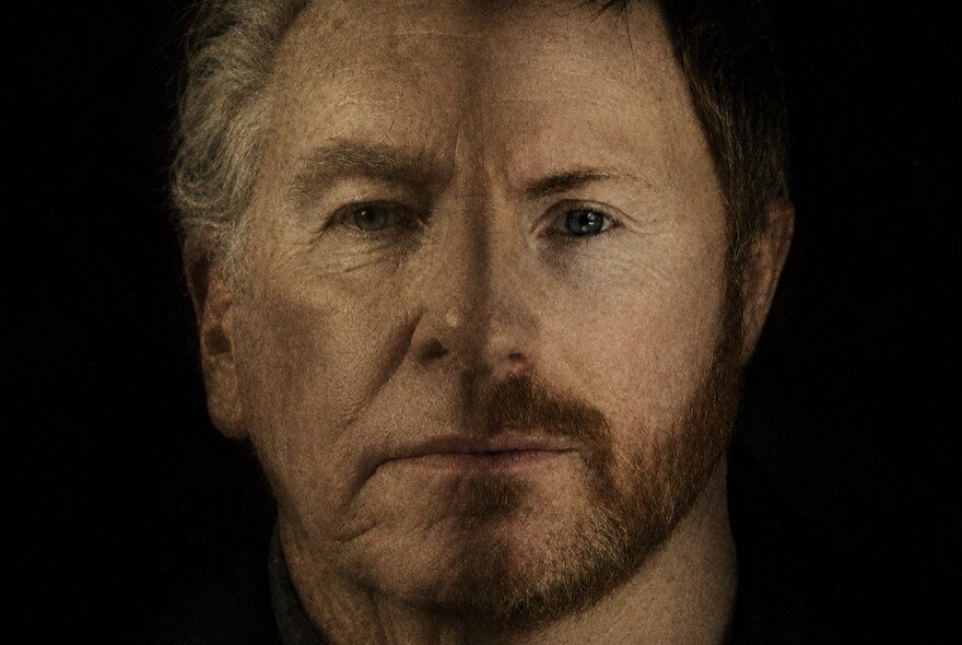 A portrait of two men merged into one face with a faint line down the centre delineating the two.