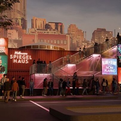 The Melbourne Spiegel Haus at night, with a line of people waiting to go into an event.