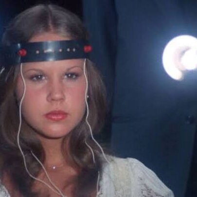 A still image from The Exorcist II showing a girl with electrodes stuck to her head in an experiment. 