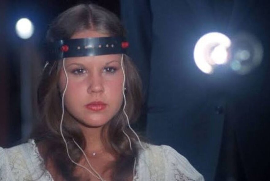 A still image from The Exorcist II showing a girl with electrodes stuck to her head in an experiment. 