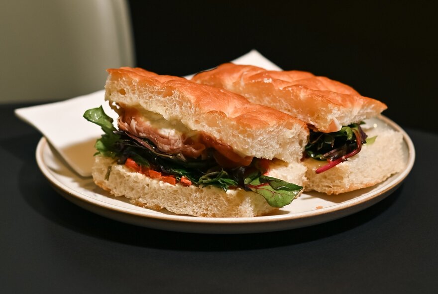 Filled foccacia on a plate with a napkin.