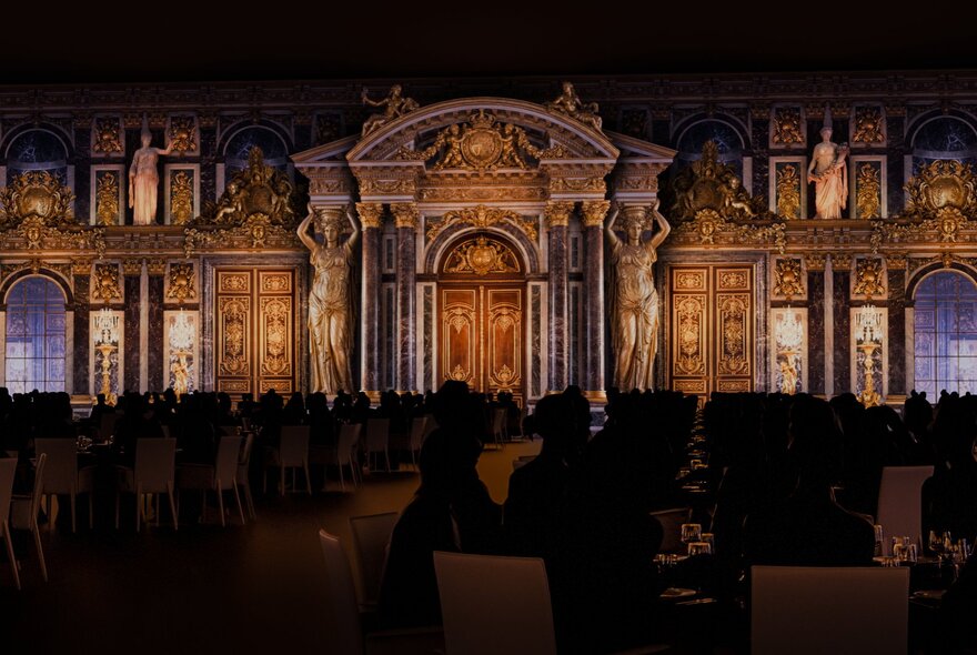 A darkened dining space with illuminations on the walls resembling Versailles at Château Merveilles.