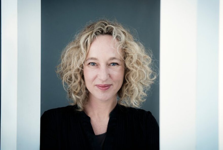 Portrait of the Wheeler Centre host, Sally Warhaft, subtly smiling at the camera.