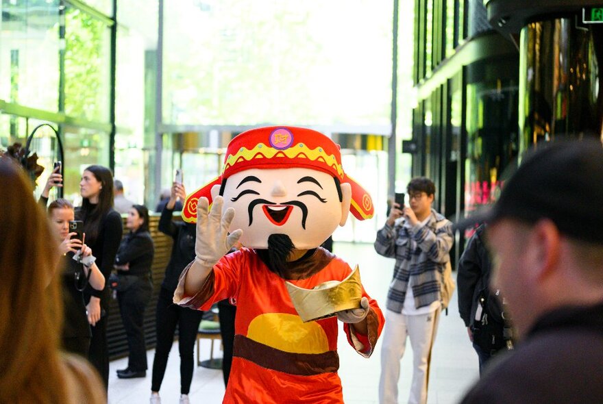 People at Collins Square outdoor plaza watching performances as part of Lunar New Year celebrations.