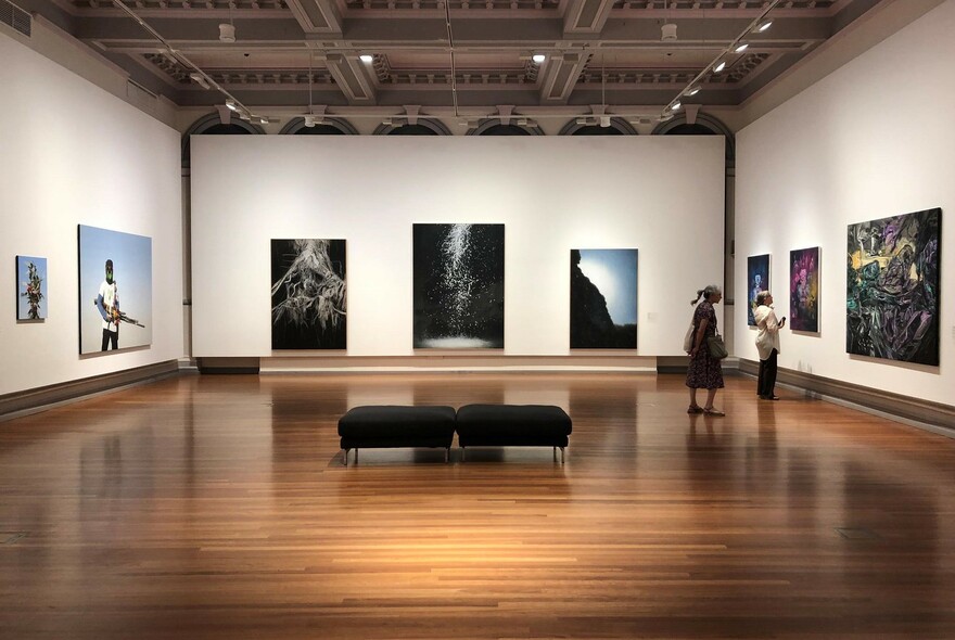 People looking at paintings in RMIT Gallery.