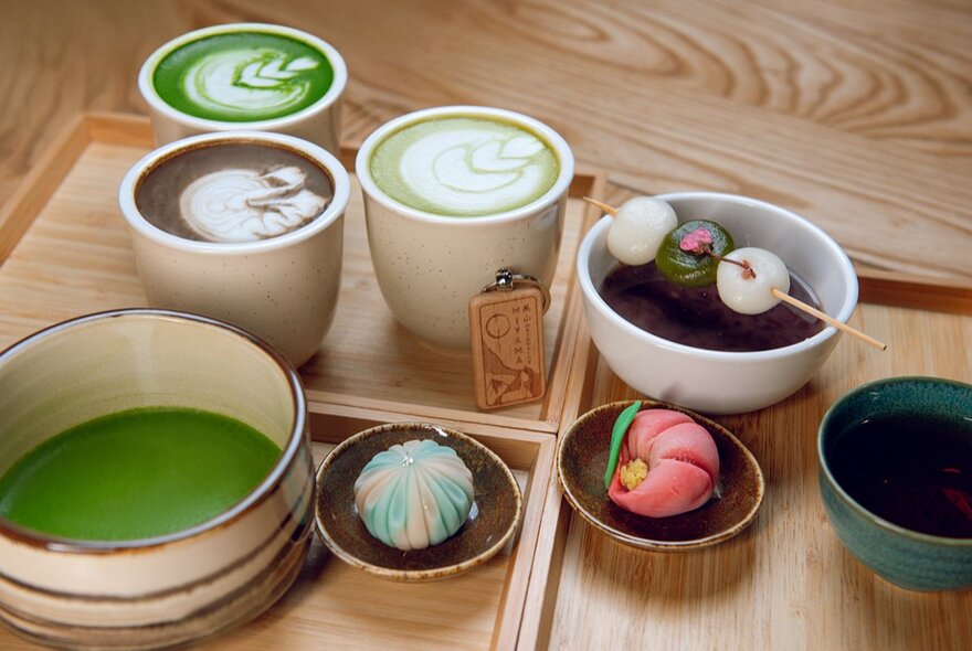 Japanese drinks and sweets on wooden trays, including matcha.