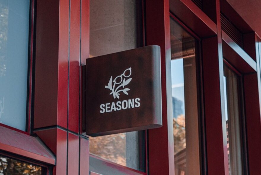 Signage for Seasons Optical hanging outside the store.