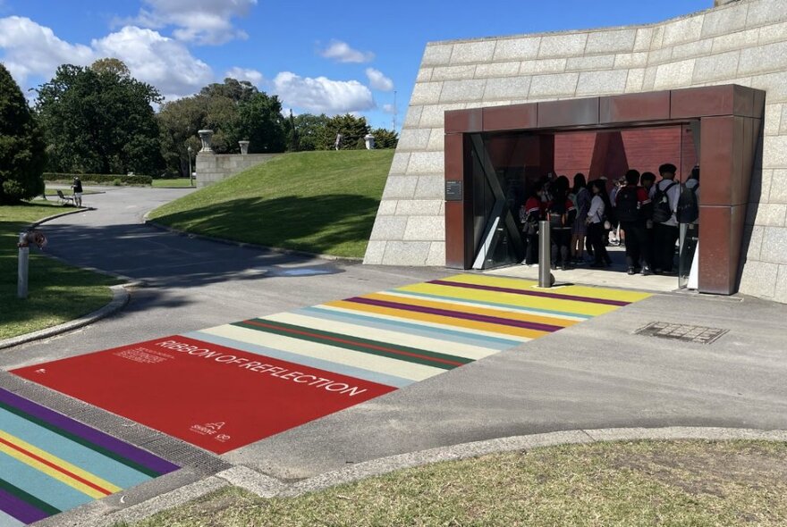 Striped colours, representing Australian military medal ribbons, along a pathway leading up to the Shrine of Remembrance.