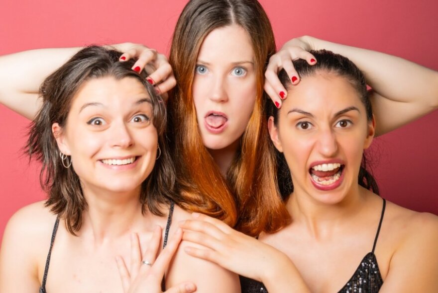 Three women posing and pulling faces