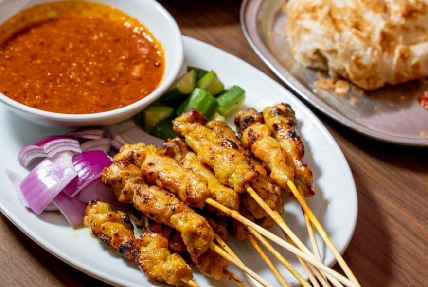 Satay sticks and a bowl of sauce.