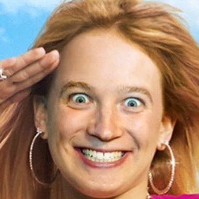 Crazed-looking woman saluting with her hand, with long blonde hair and large hoop earrings.