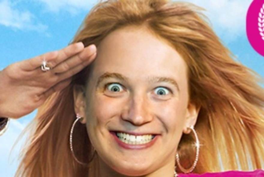 Crazed-looking woman saluting with her hand, with long blonde hair and large hoop earrings.