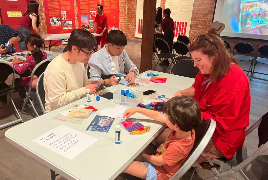 Children and adult working at an activity table.