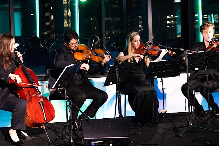 A sting quartet performing in room.
