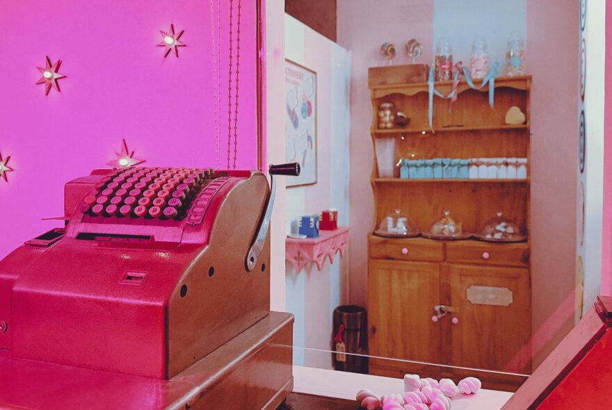 An escape designed to look like a retail shop with a wooden cabinet and an old-fashioned pink cash register.