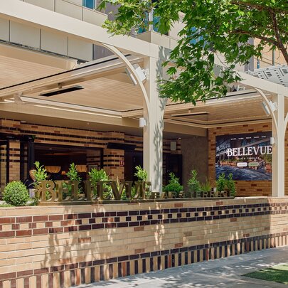 The external facade of Bellevue Bar and Terrace with a low brick fence in front of the riverfront terrace.